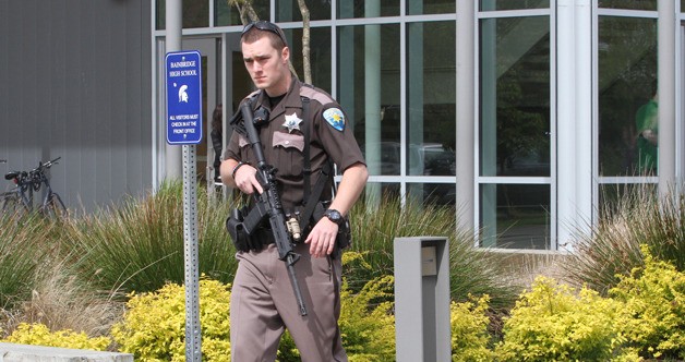 A deputy with the Kitsap County Sheriff's Office walks to a staging area near the front of Bainbridge High during Wednesday's lockdown.
