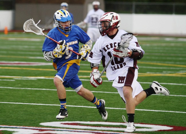 Connor Cather defends Mercer Island's Doug Mahoney during Saturday's non league contest at Mercer Island High School. Mahoney scored six goals as the Islanders defeated the Spartans 18-3.