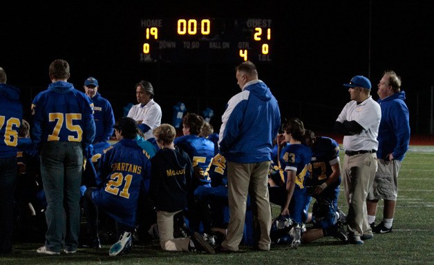 The Bainbridge Spartans gather on the sideline after their heartbreaking 21-19 loss to Lakeside.