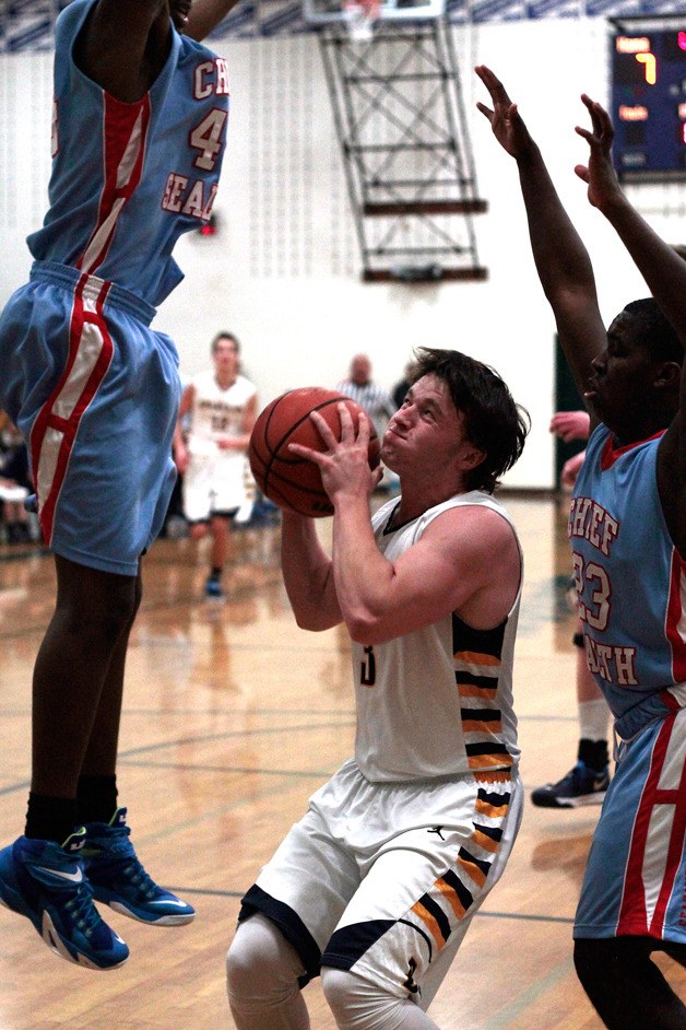 Spartan Trent Schulte battles through the defensive efforts of Chief Sealth for a shot at the hoop early in Tuesday's home game.