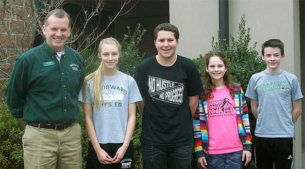 Woodward Middle School principal Mike Florian stands with the school’s February Students of the Month: Janelle Siefert