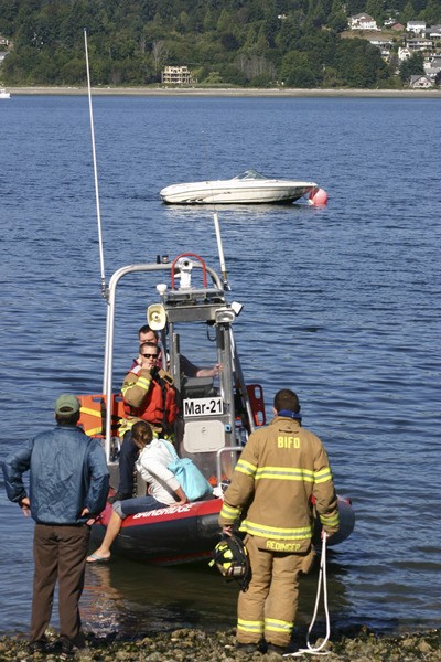 Bainbridge firefighters took a man and woman to shore Monday after their boat's engine malfunctioned.