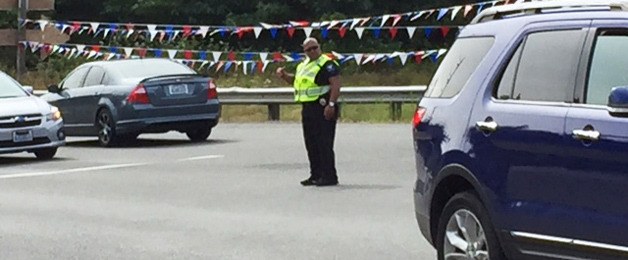 A Suquamish Police officer directs traffic at the Suquamish Way-Highway 305 intersection.