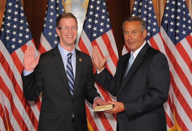 U.S. Rep. Derek Kilmer stands with Speaker of the House John Boehner as the 6th District Congressman takes the oath of office for his second term.