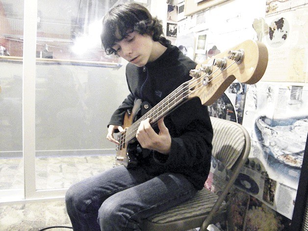 A student brushes up his bass skills with instructor Steve Newton. The Island Music Center provides an opportunity for students to build a passion for the arts.