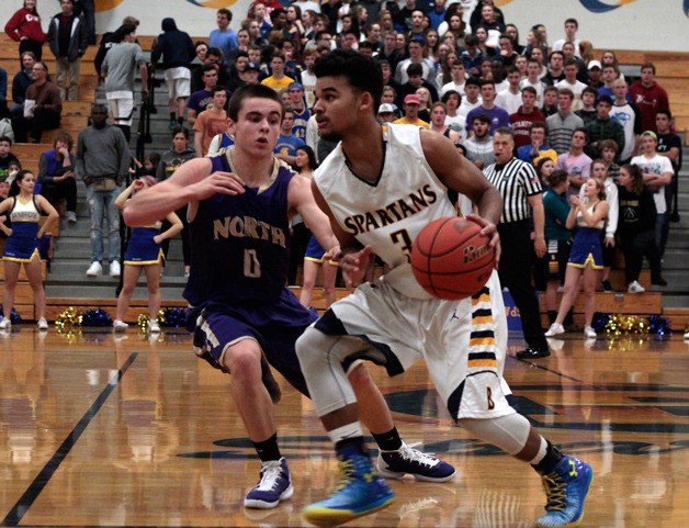 Bainbridge junior guard Marcus Clyde drives the ball down the court late in last week's game against the North Kitsap Vikings.