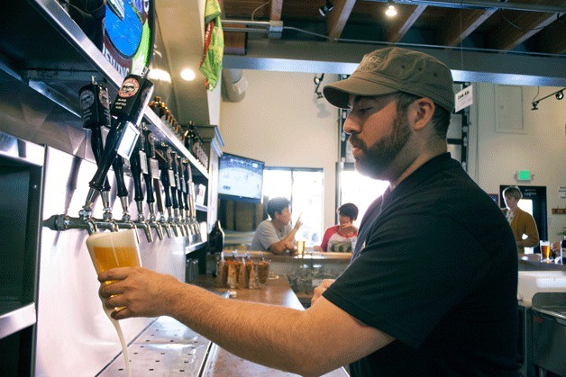 Art Carbajal pours a pint at the Bainbridge Island Brewery's tap room on the Coppertop Loop.