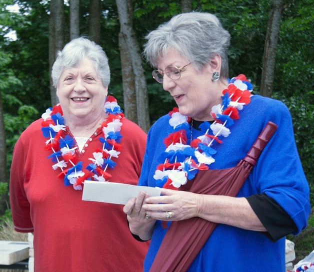 Susan Barrington and Ruth Flanagan accept a check of $1