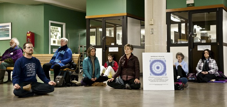 Commuters on the 6:20 p.m. ferry run on Dec. 22 were greeted by a group of flash-mob meditators who sat in silence and later
