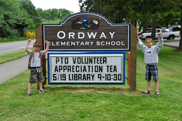 Milo and Tomas McIntosh stand in front of the new readerboard at Ordway Elementary.
