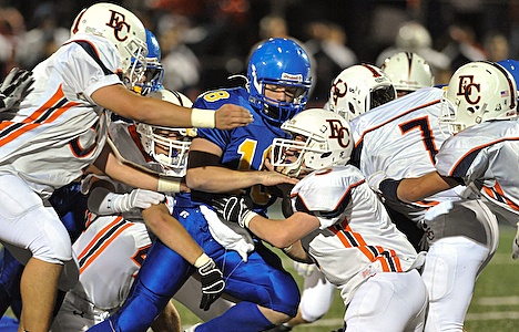 Bainbridge Spartans player Jordan Wagner defends against a wall of Eastside Catholic players Friday during home action.