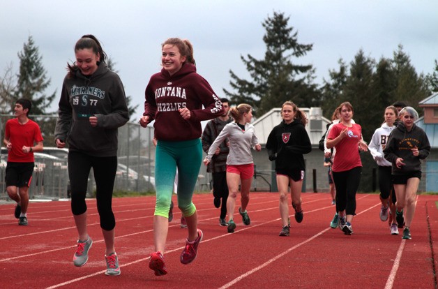 A warm-up lap marks the start of a recent Bainbridge High School track and field team practice session.