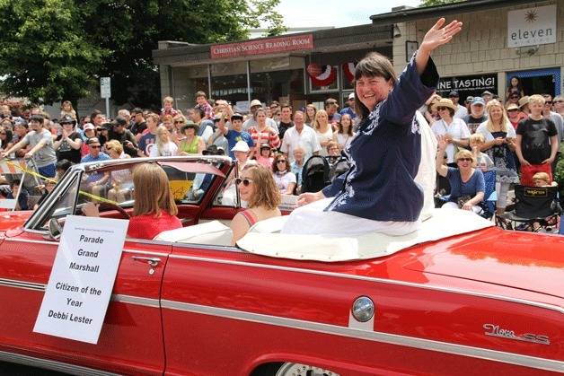 Parade Grand Marshal (and Citizen of the Year) Debbi Lester waves to the crowd gathered for this year's Fourth of July parade in Winslow.