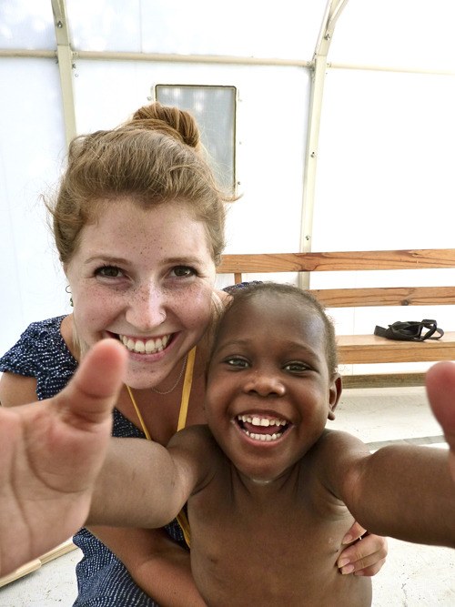 Rachel Harmon jokes with one of the children she worked with through Children’s Nutrition Program in Haiti.