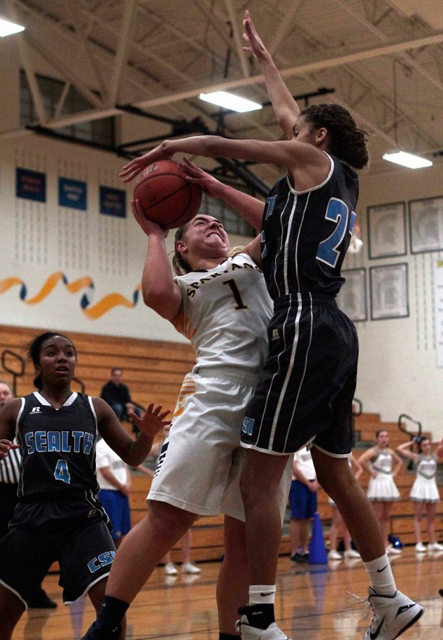 Bainbridge's Katie Usellis comes under intense pressure while taking it to the rack against Chief Sealth.