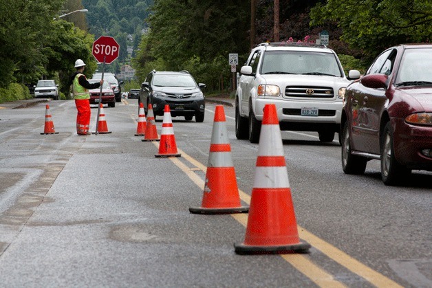 Drivers creep along Madison Avenue after the roadway was restricted to one lane for the water line project.
