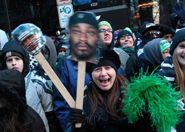 Enthusiastic Seahawks fans gather along Fourth Avenue to celebrate Seattle's world champions football team.