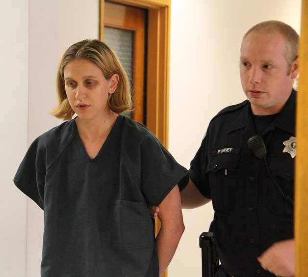 Jessica M. Fuchs is escorted to a Kitsap County courtroom Monday to face charges that she sexually assaulted a 16-year-old boy she taught at Bainbridge High School.