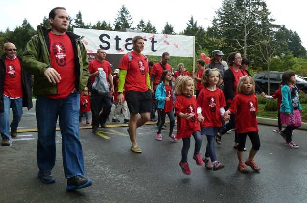 Walkers in the first KiDiMu Walk step out during last year's fundraiser. The walk returns to Winslow on Saturday