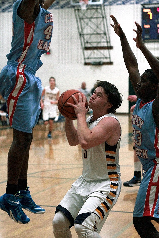 Spartan Trent Schulte battles through the defensive efforts of Chief Sealth for a shot at the hoop early in Tuesday’s game.