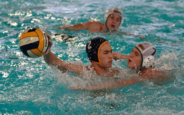 Sophomore driver Harrison Shinohara fends off the defensive efforts of Peninsula High during Tuesday’s home match.