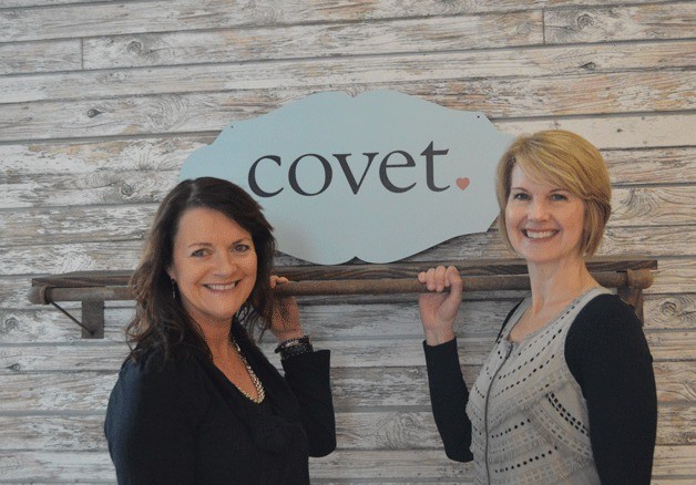 Janet Davis and Pamela Kinkead show off the new signage for Covet
