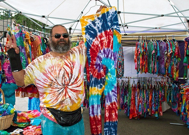 Artist Peter Simon of “To Dye For” poses with some of his crazy creations at the sixth annual Taste of Lynwood block party.