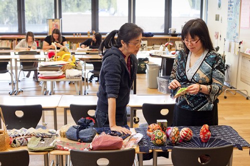 Michiko Sackett (at left) and Bainbridge High School Japanese teacher Lani Kawasaki sort through donated Japanese items that will be auctioned off May 14 at Seabold Hall as a fundraiser for Japanese victims of the March 11 earthquake and tsunami.