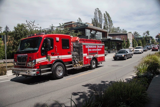 A fire engine from the Bainbridge Island Fire Department leads the procession for departed Seattle Firefighter Joseph Kane Wednesday