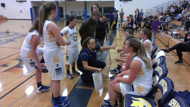 Spartans Coach Nicole Hebner talks to her team during a break in action against Sequim.