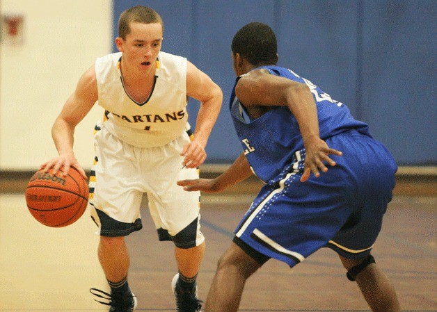 Blake Swanson looks for a path to the paint against Seattle Prep's Jordan Kitchen.