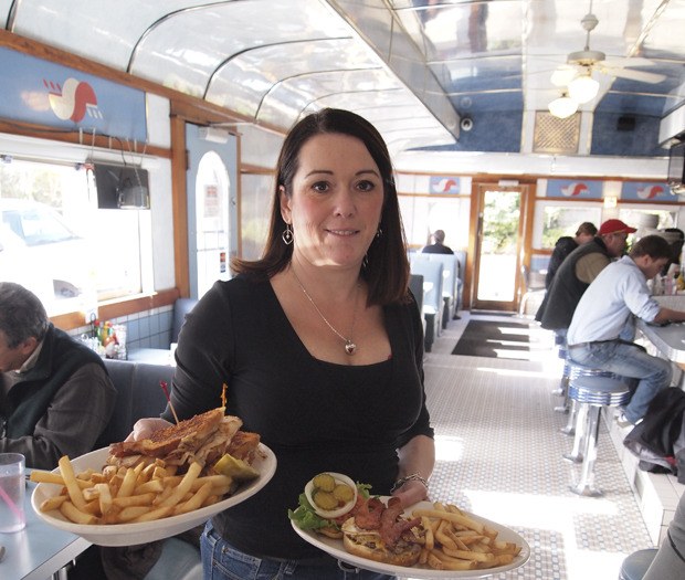 Owner Cyndi Moody delivers plates of food to customers.  The 50s-style diner recently began staying open for dinner until 8 p.m. Thursday - Saturday and is looking to further expand hours.