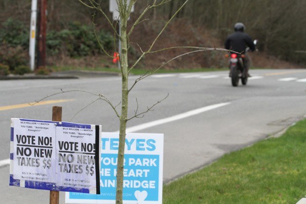 Campaign signs for and against the Bainbridge parks' proposal for a purchase of the Sakai property line Madison Avenue north of the site of the new proposed park.