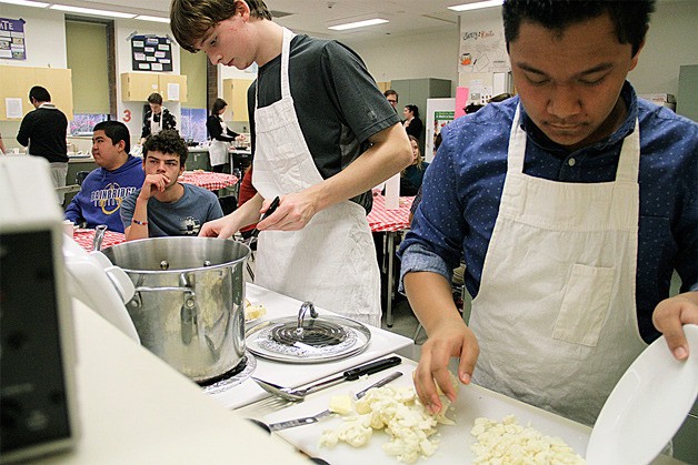 BHS student chefs Morgan Du Bois and Kenny Dosono assemble their artisan grilled cheese during the recent cookoff.
