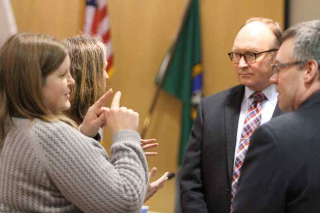 Mike Scott talks to other city officials after his appointment in late January.