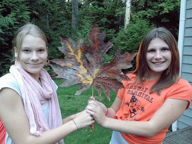 Paige Bouma and Julia Jakubik and their big leaf.