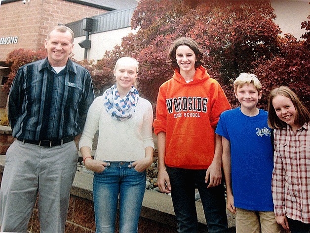 Woodward Middle School Principal Mike Florian stands with the school’s September Students of the Month