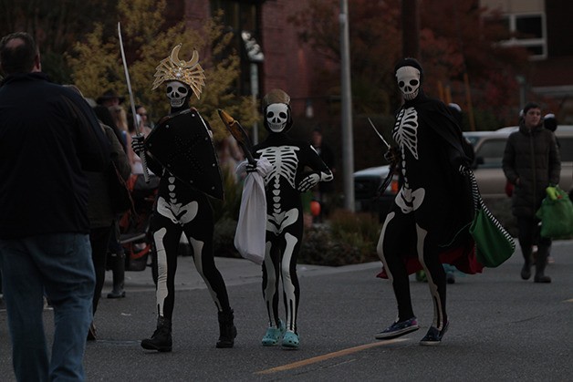 Skeletons rattle down Winslow Way at last year's trick or treat event.