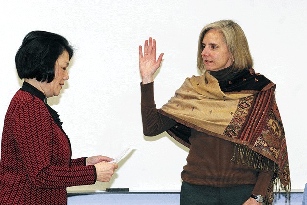 District Superintendent Faith Chapel gives the oath of office to new board member Mary Ellen “Mev” Hoberg at the board meeting Wednesday.