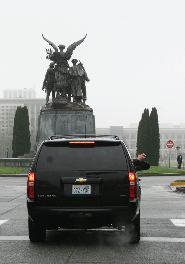 Outgoing Washington governor Chris Gregoire waves goodbye as she leaves the capitol after Jay Inslee's inauguration Wednesday.