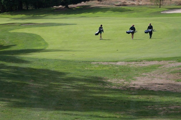 A trio of returning players on the Bainbridge High varsity girls golf team make their way through a practice round at Wing Point Golf & Country Club last week.