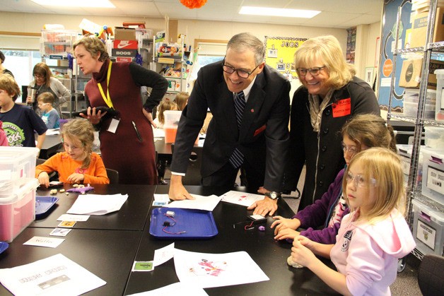Gov. Jay Inslee and First Lady Trudi Inslee talk with first-graders at Blakely Elementary as they work with electronic circuits and motors during a STEM instructional period.