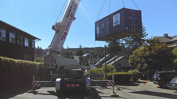A large crane unloads a new food waste biodigester at the Harbour Public House in downtown Winslow last week.
