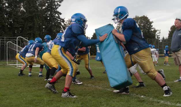 The Bainbridge High School varsity football team works through a soggy practice session Monday amidst scattered rain storms. The team’s first game is 7 p.m. Friday