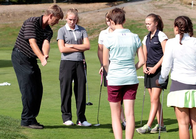 BHS Coach Ian Havill gives pointers to Spartan girls golfers.