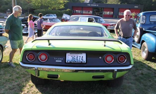 Visitors to the Bainbridge Island Classic Car Cruise-In check out a Plymouth Barracuda.