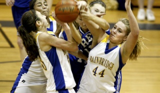 BHS forward Anna Wood goes for a rebound with other teammates Wednesday during home action against Seattle Prep.