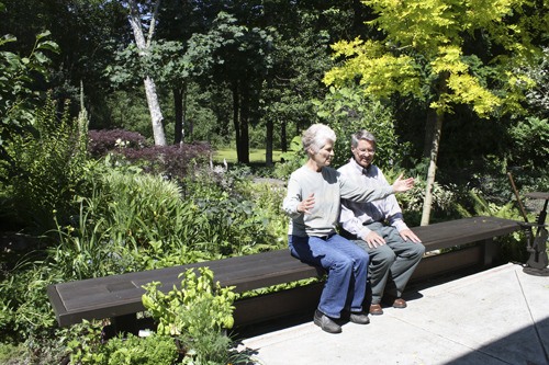 Leslie Marshall and Herb Hethcote relax in their lush in-town garden filled with “native plants and allies.” Their garden is featured on the 2011 Bainbridge in Bloom Garden Tour July 8-10.