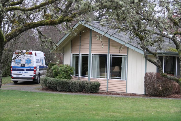 An Olympic Ambulance unit is parked outside a home on Killdeer Lane Northeast on Tuesday. City officials have told the company that it cannot operate out of a residential neighborhood.
