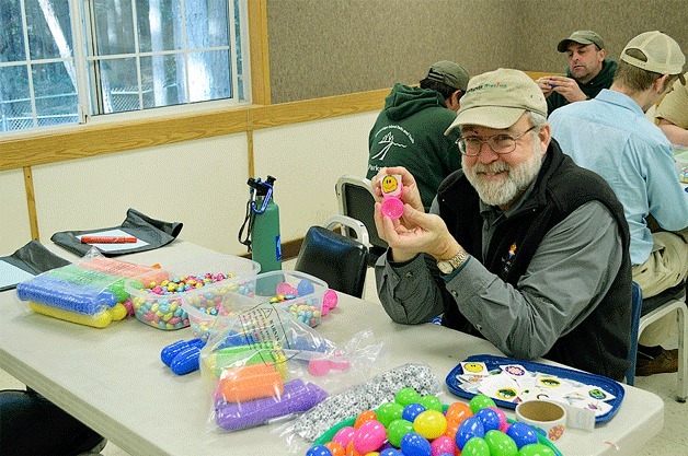 Park Commissioner Kirk Robinson loads up the goodies at an egg-stuffing party on February 26. Altogether